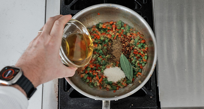 adding herbs to peppers