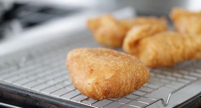 resting fried fish on a batter