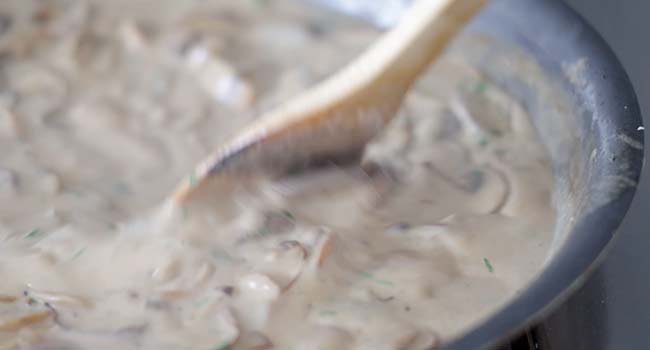 adding parsley to a sauce