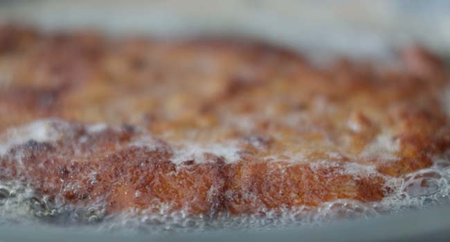 basting a pork schnitzel