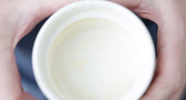 adding butter and sugar to a ramekin