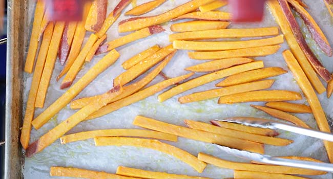 flipping sweet potato fries over