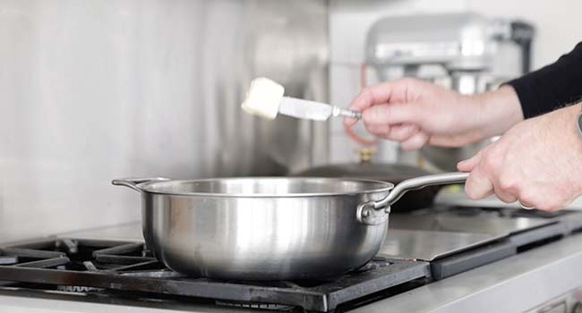 adding butter to a pan