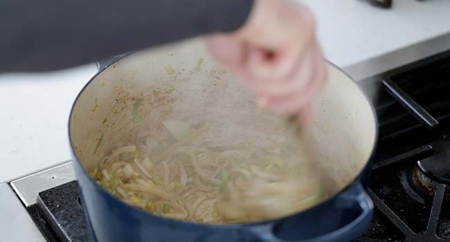 mixing onions in a pot