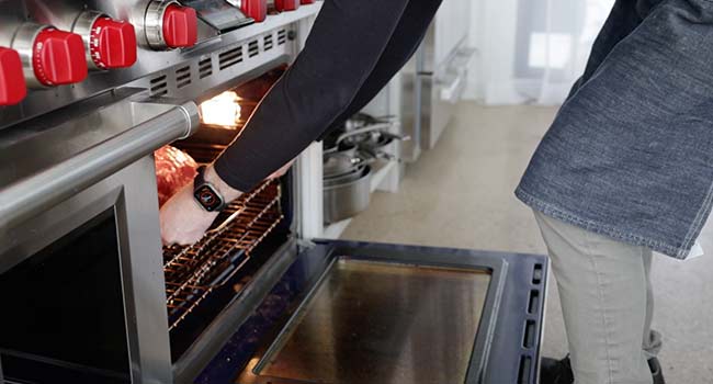 adding roast beef to an oven