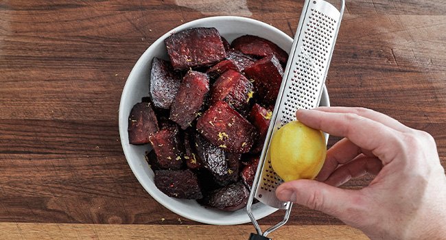 adding lemon zest to roasted beets