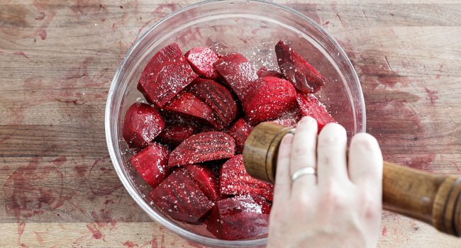 seasoning beets in a bowl