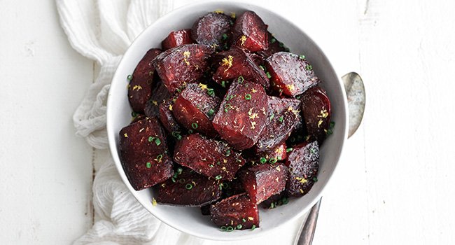 chives and lemon zest on roasted beets in a bowl