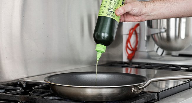 adding oil to a pan