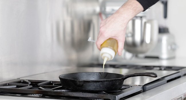 adding oil to a pan