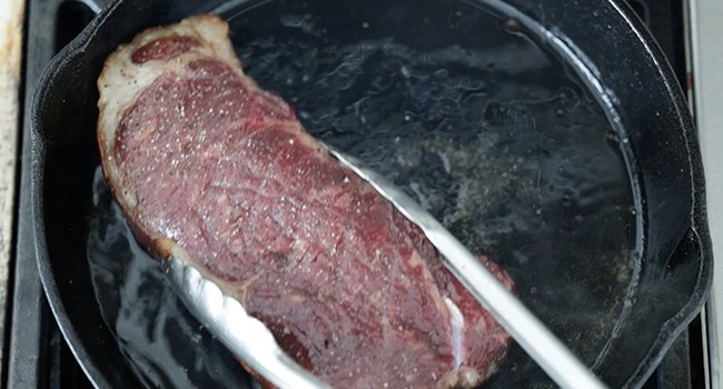 moving a steak around in a pan