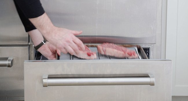 adding steaks to a refrigerator