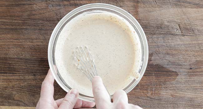 whisking a chipotle ranch in a bowl