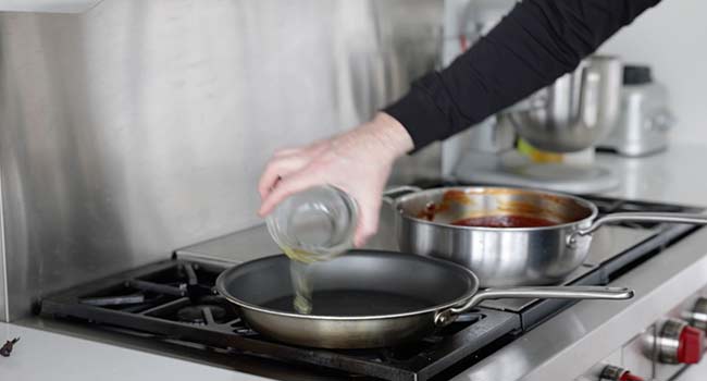 adding oil to a pan