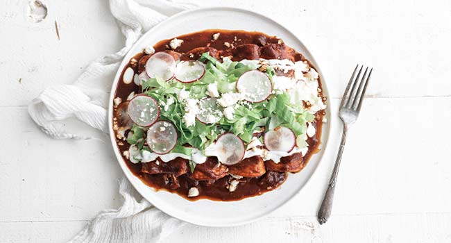 chicken enchiladas with crema and lettuce