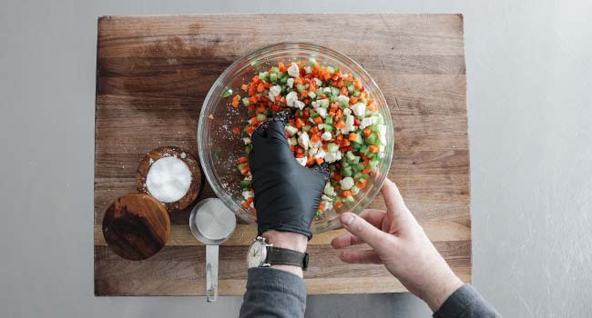 mixing vegetables with salt