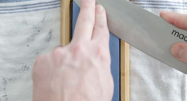 scraping a knife on a whetstone