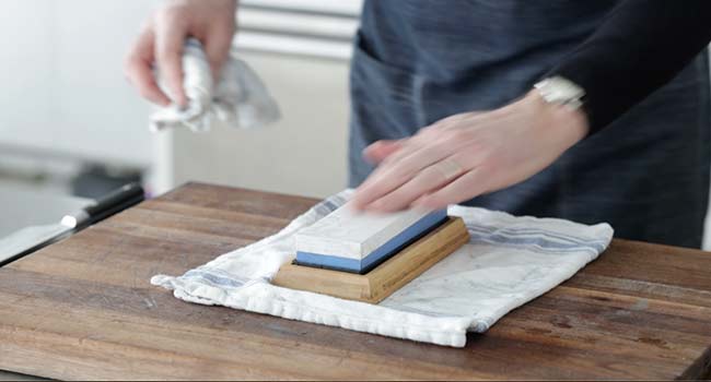 adding water to a polishing whetstone