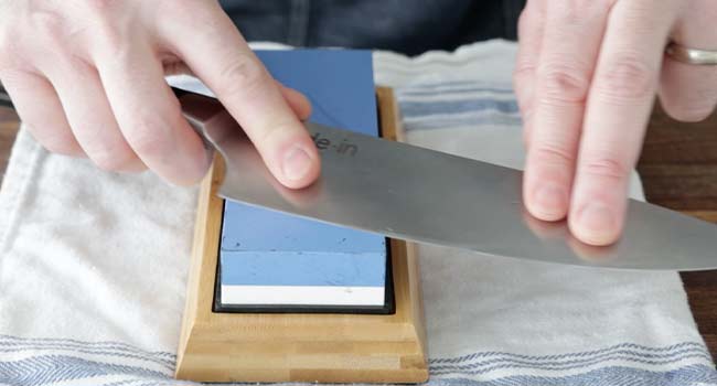 sharpening a knife on a whetstone