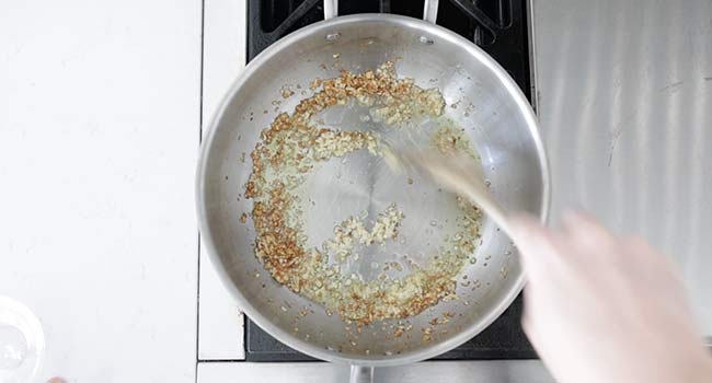 mixing garlic into shallots