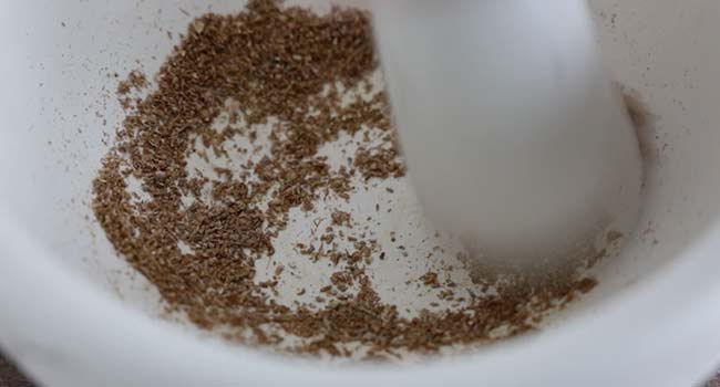 grinding seeds with a mortar and pestle