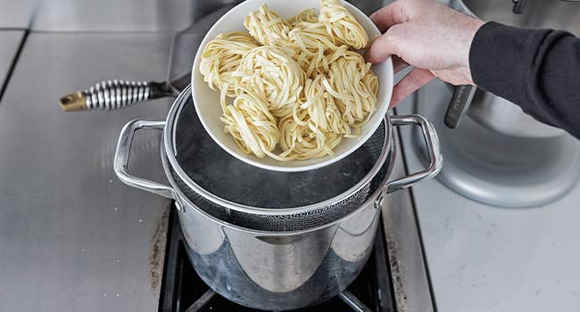 adding pasta to water