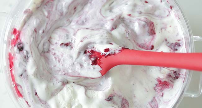 folding berries with cream