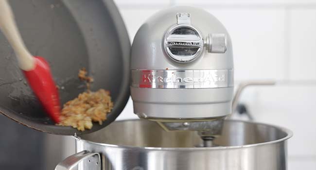 adding shallots and garlic to a stand mixer