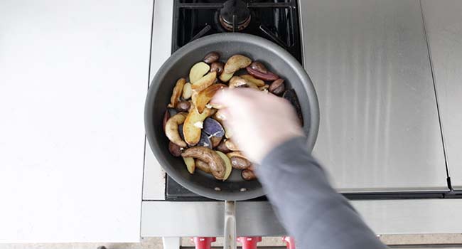 adding garlic to roasted fingerling potatoes