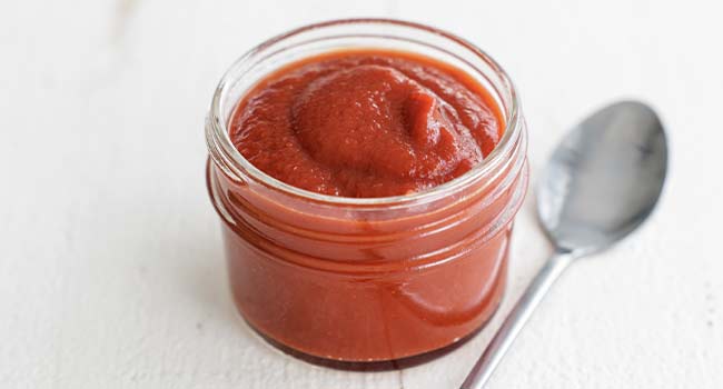 ketchup in a jar with a spoon