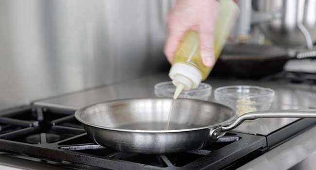 adding oil to a pan