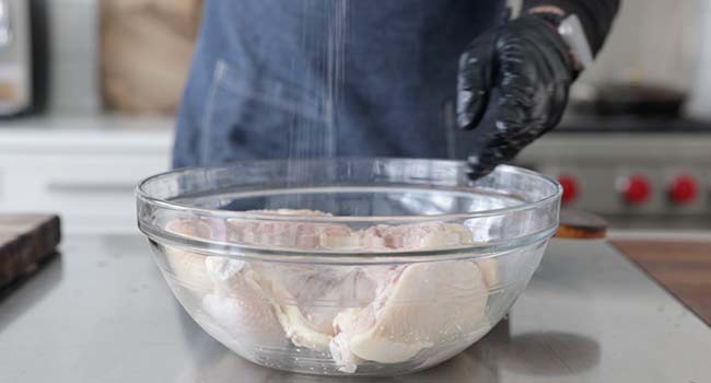 seasoning a flattened chicken