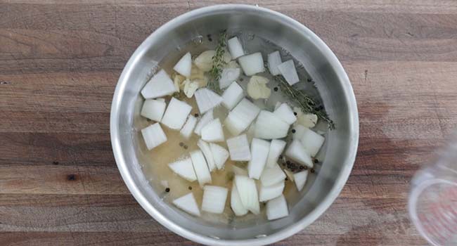 onions and herbs in a pot