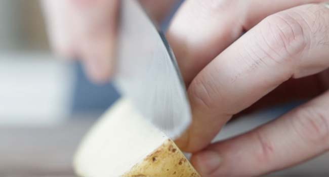 slicing potatoes into wedges