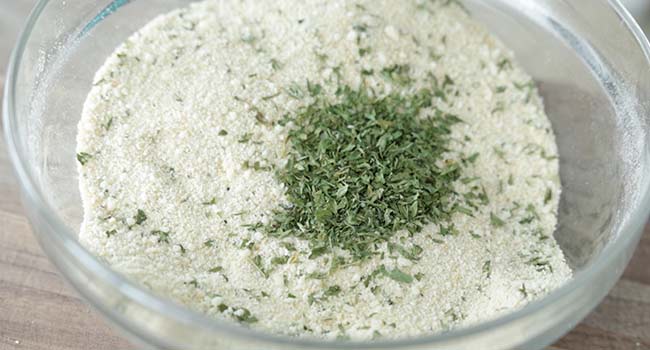 adding herbs to breadcrumbs