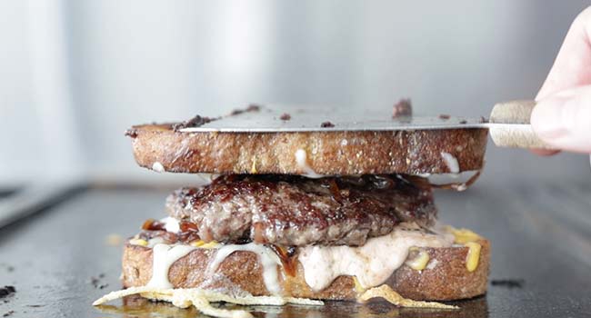 patty melt with russian dressing on a griddle