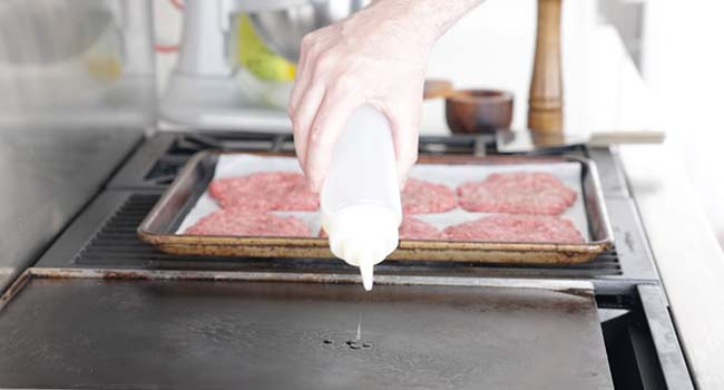 adding oil to a griddle