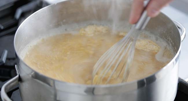 stirring polenta into hot chicken stock