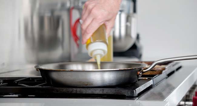 adding oil to a pan