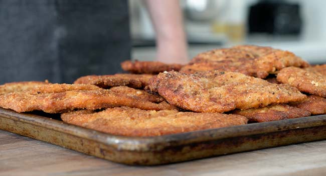 chicken cutlets on a sheet tray