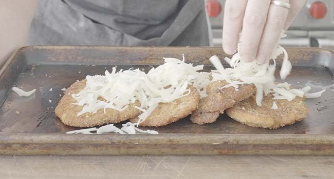 adding cheese to chicken cutlets