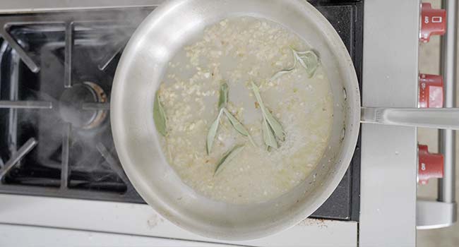 wine and sage in a pan