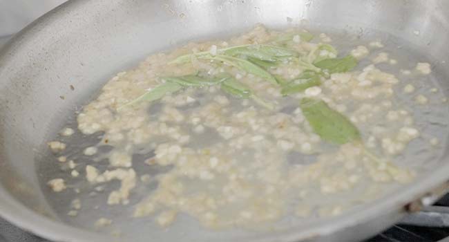 shallots with sage in a pan