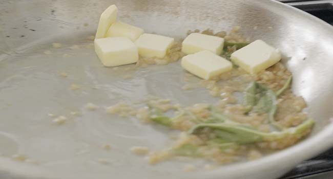 mixing butter with sage and shallots