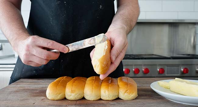 adding butter to buns