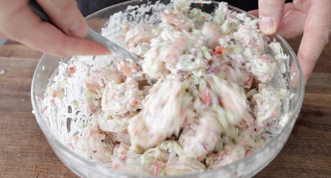 mixing a shrimp salad