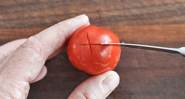 slicing an X on a tomato