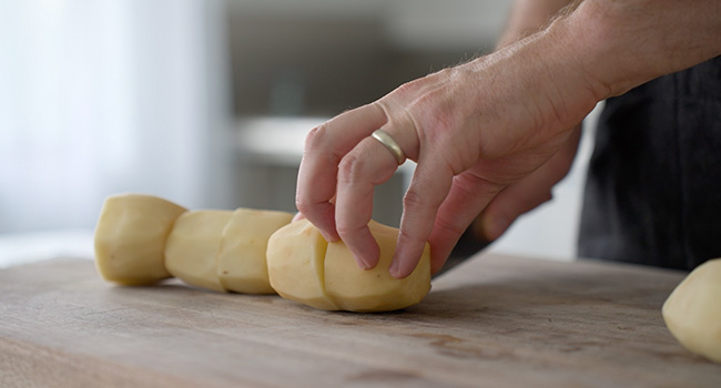 slicing potatoes in half