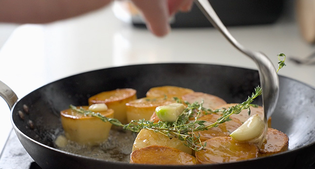 seasoning potatoes while basting