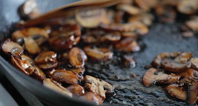 roasted mushrooms in oil in a pan